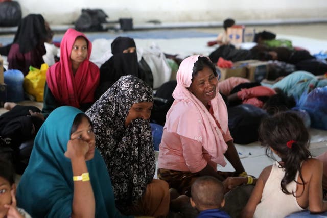<p>Rohingya refugees return to temporary shelter after being forced out by local students in Indonesia</p>