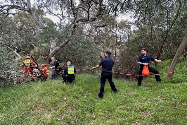 <p>Emergency workers rescuing a woman from flood waters after heavy rain at the Buchan campground in east Gippsland, located east of Melbourne</p>