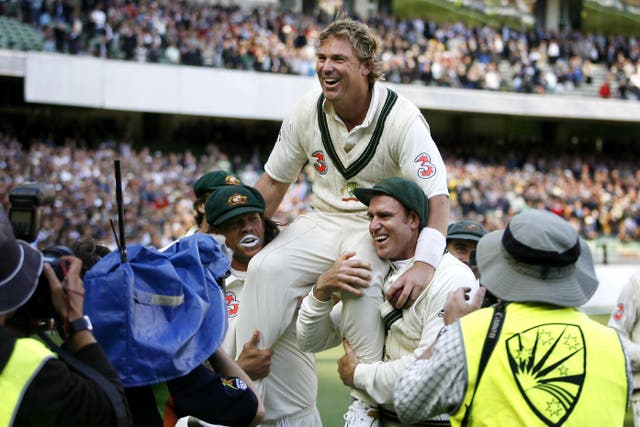 Shane Warne is carried from the field by his team-mates after victory over England at the MCG (Gareth Copley/PA)
