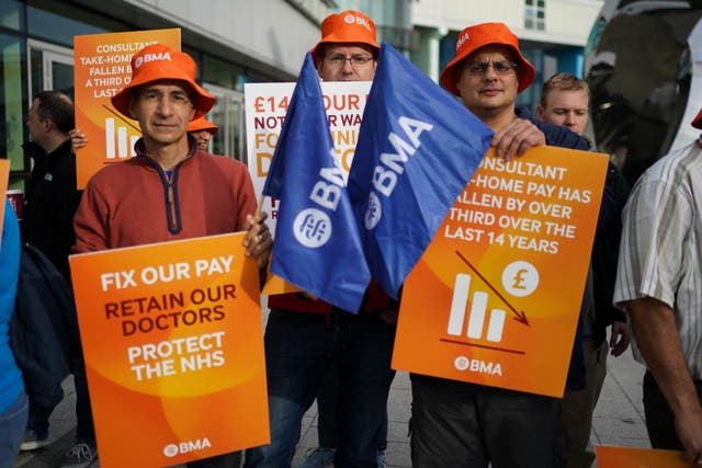 <p>Junior doctors and medical consultant members of the British Medical Association on the picket line on Monday (Jacob King/PA)</p>