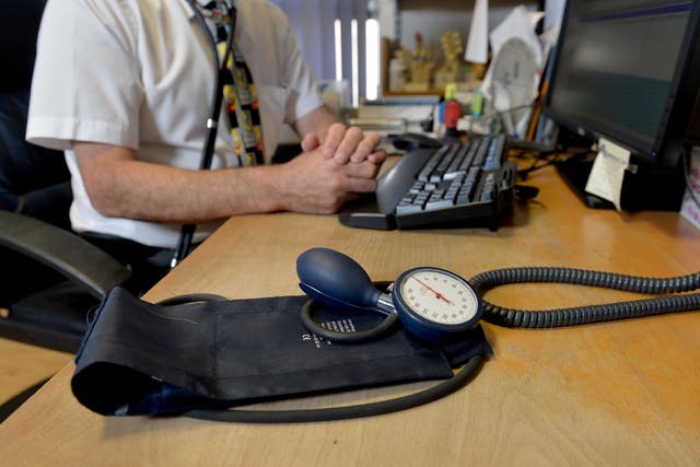 A GP at their desk (Anthony Devlin/PA)