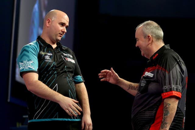 Rob Cross (left) stunned Phil Taylor on this day in 2018 (Steven Paston/PA)