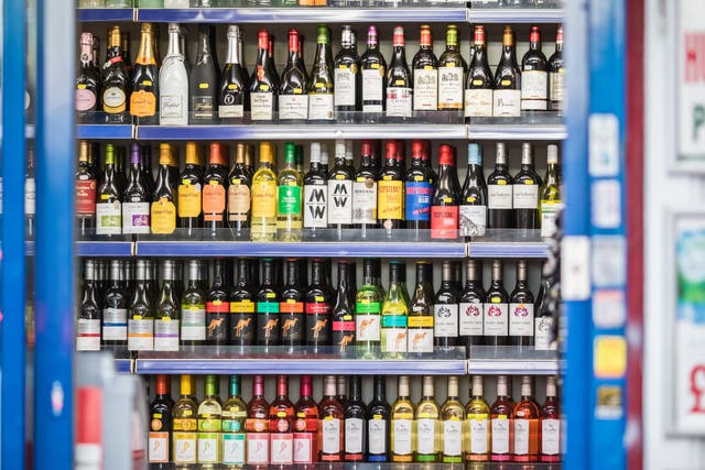 <p>A selection of wines displayed on shelf in an off-licence shop</p>
