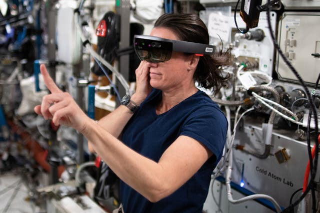 <p>Nasa astronaut Megan McArthur wears a HoloLens VR headset to test an augmented reality application during Expedition 65</p>