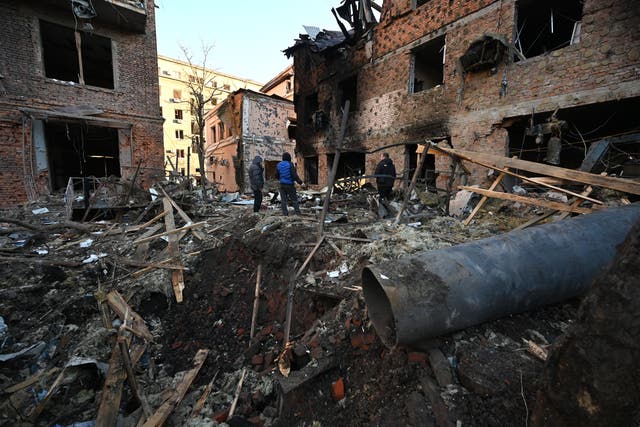 <p>Local residents inspect damages outside an apartment building after the overnight Russian drones attack in Kharkiv last week </p>